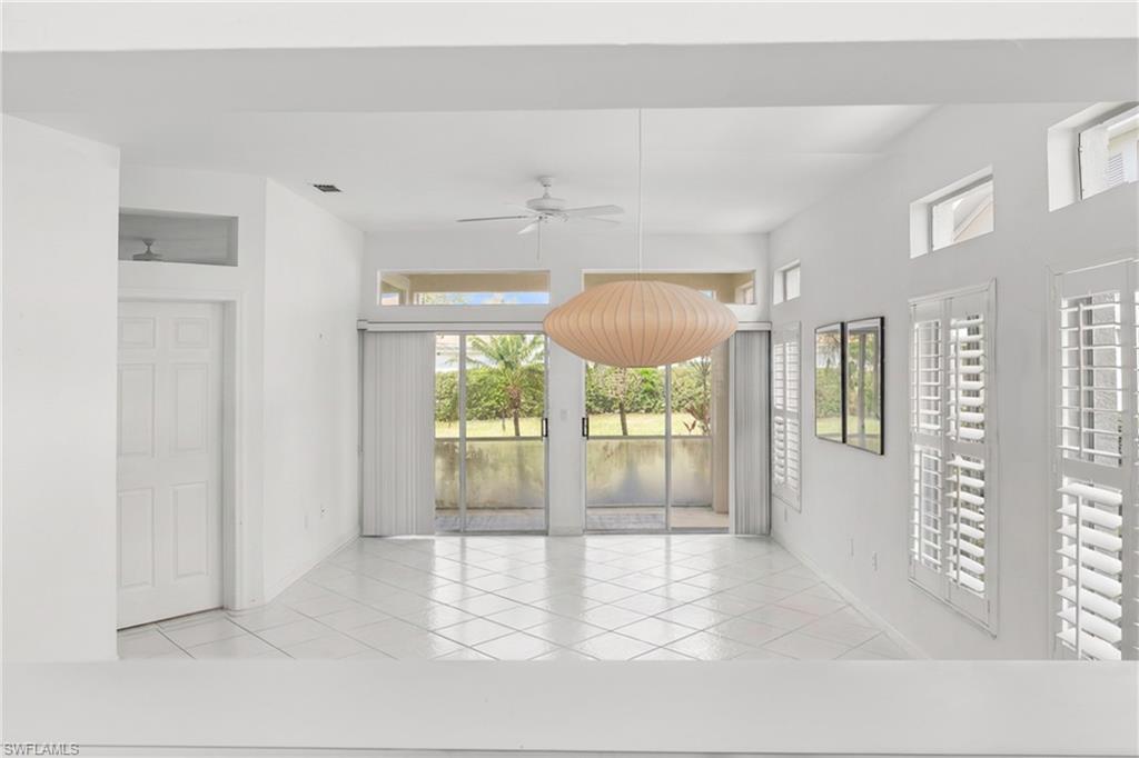 Spare room with a ceiling fan and light tile patterned floors