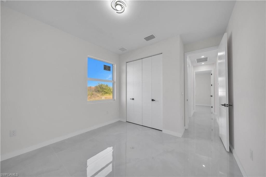 Unfurnished bedroom featuring baseboards and a closet