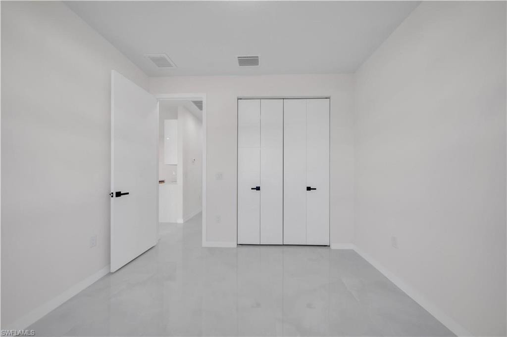 Unfurnished bedroom featuring baseboards and a closet