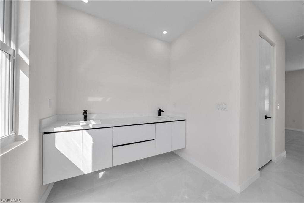 Bathroom featuring double vanity and recessed lighting