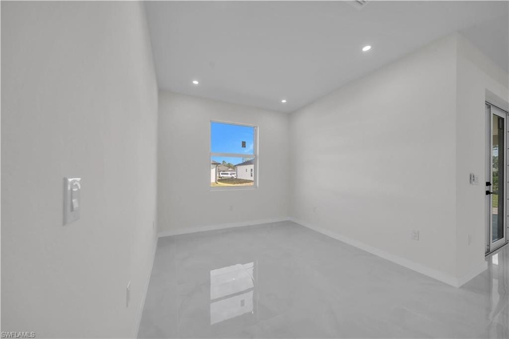 Unfurnished room featuring recessed lighting and concrete flooring