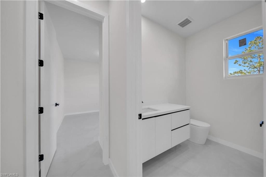 Bathroom featuring vanity and toilet