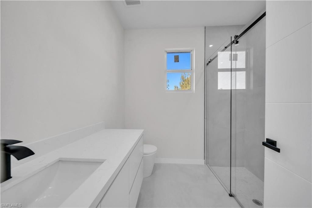 Bathroom with a shower stall and vanity