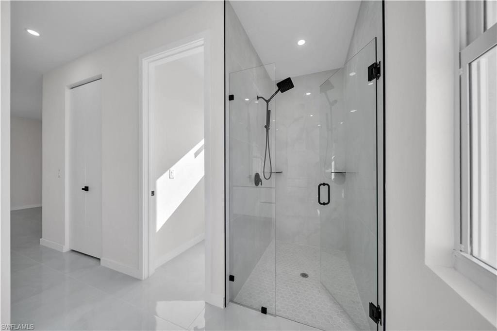 Full bathroom with a shower stall and recessed lighting