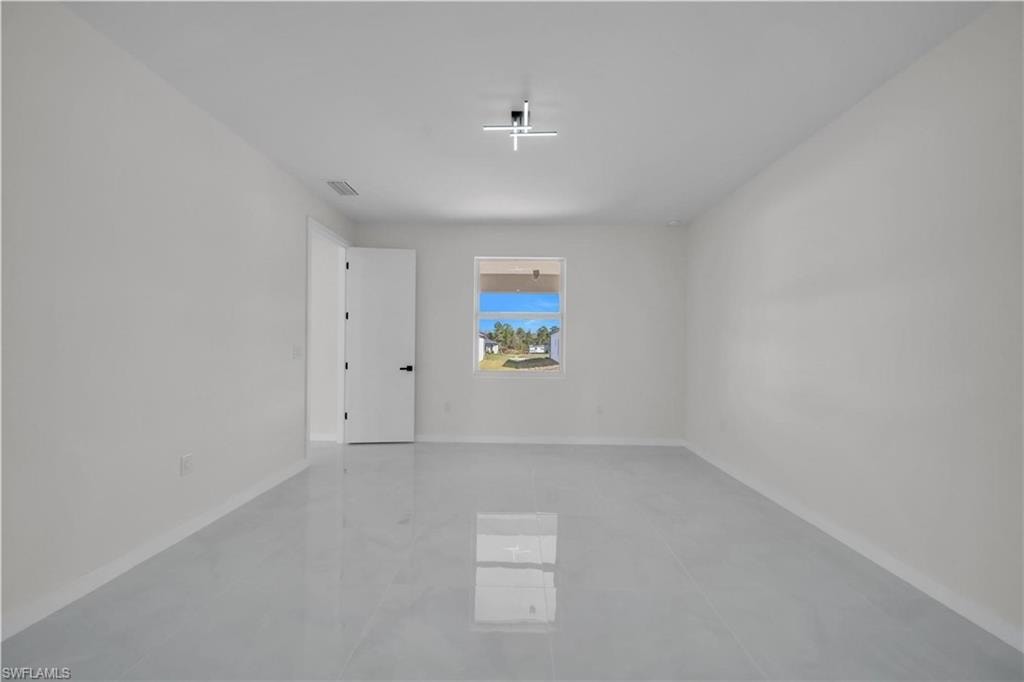 Unfurnished room featuring baseboards