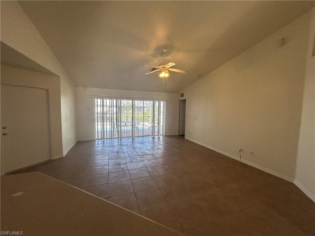 Spare room featuring ceiling fan and vaulted ceiling