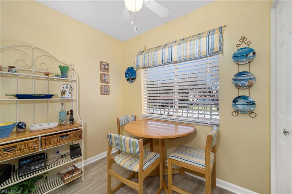 Dining area with light wood-style flooring and ceiling fan