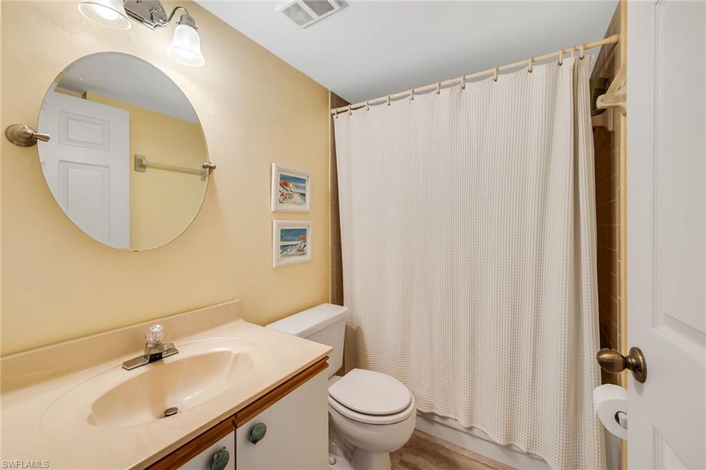 Full bath featuring vanity and shower / tub combo with curtain