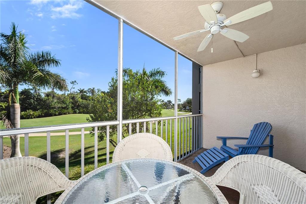 Sunroom / solarium featuring outdoor dining space, a balcony, ceiling fan, and golf course view