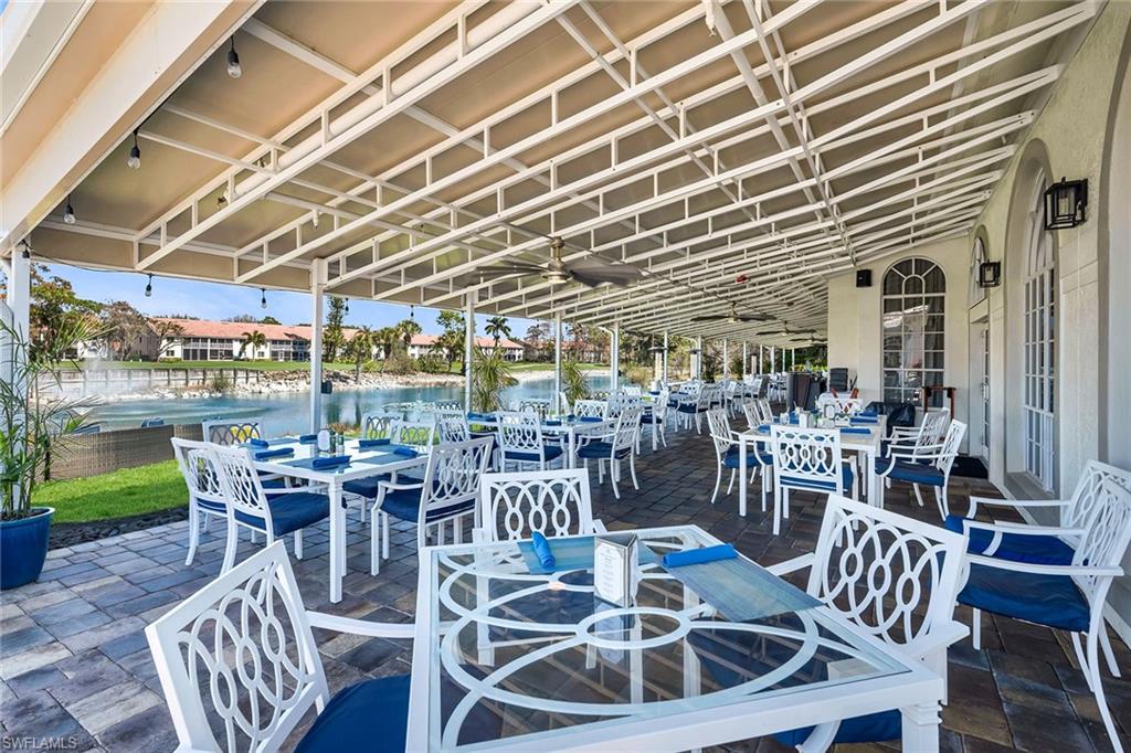 View of patio with outdoor dining space, a water view, and a residential view