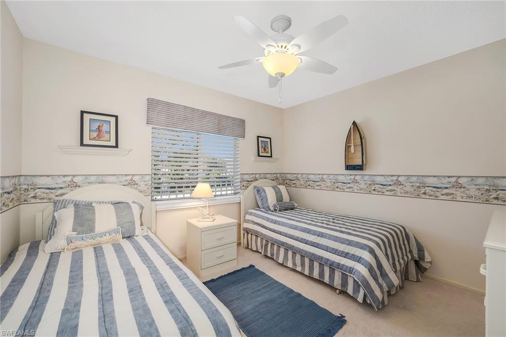 Bedroom featuring light carpet and a ceiling fan