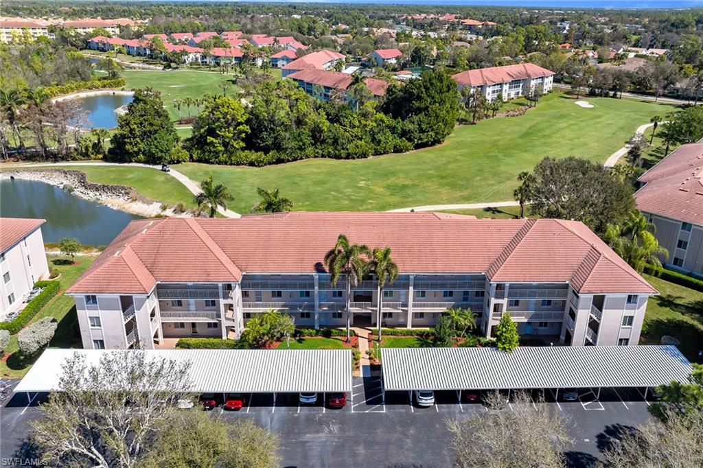 Drone / aerial view of a golf club and a nearby body of water