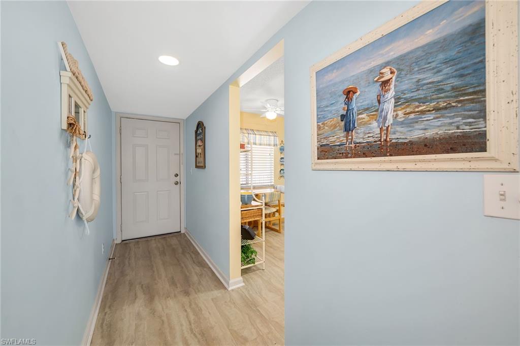 Entryway with wood finished floors and ceiling fan