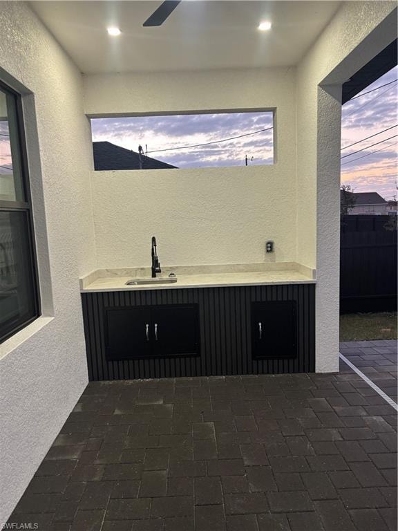 Patio terrace at dusk with a patio area and a sink