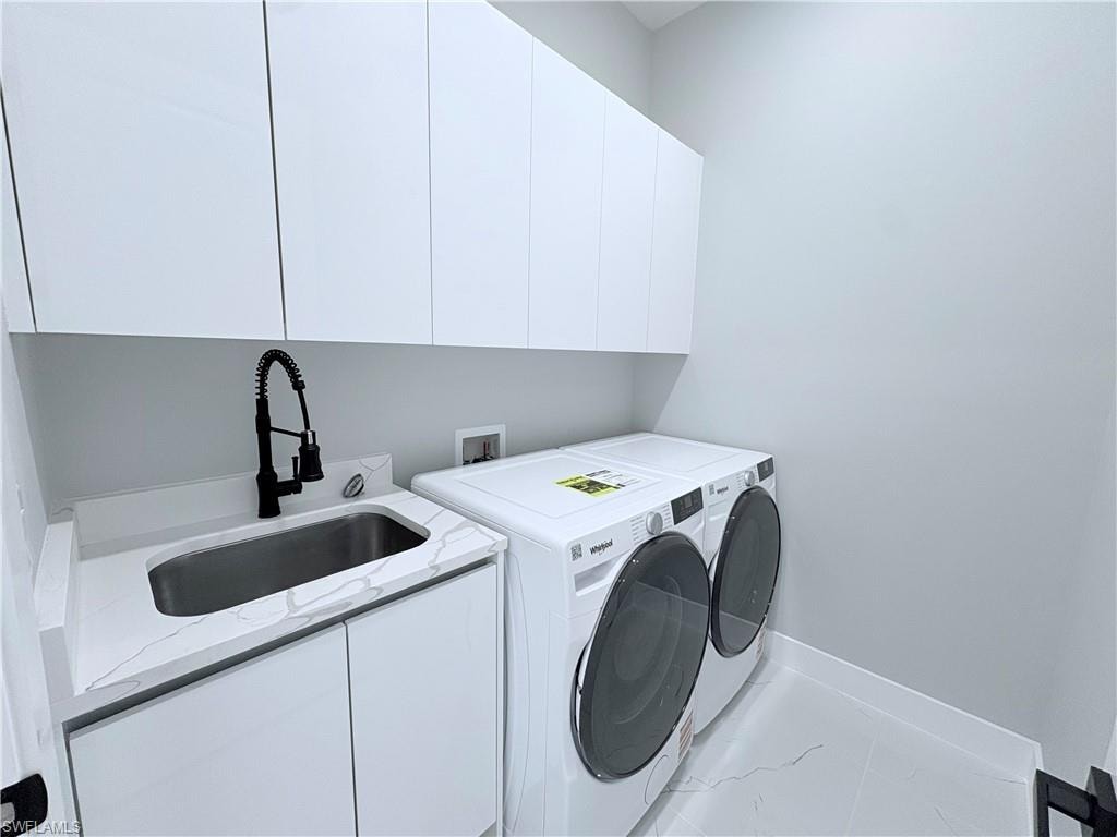 Laundry area with washing machine and clothes dryer and cabinet space