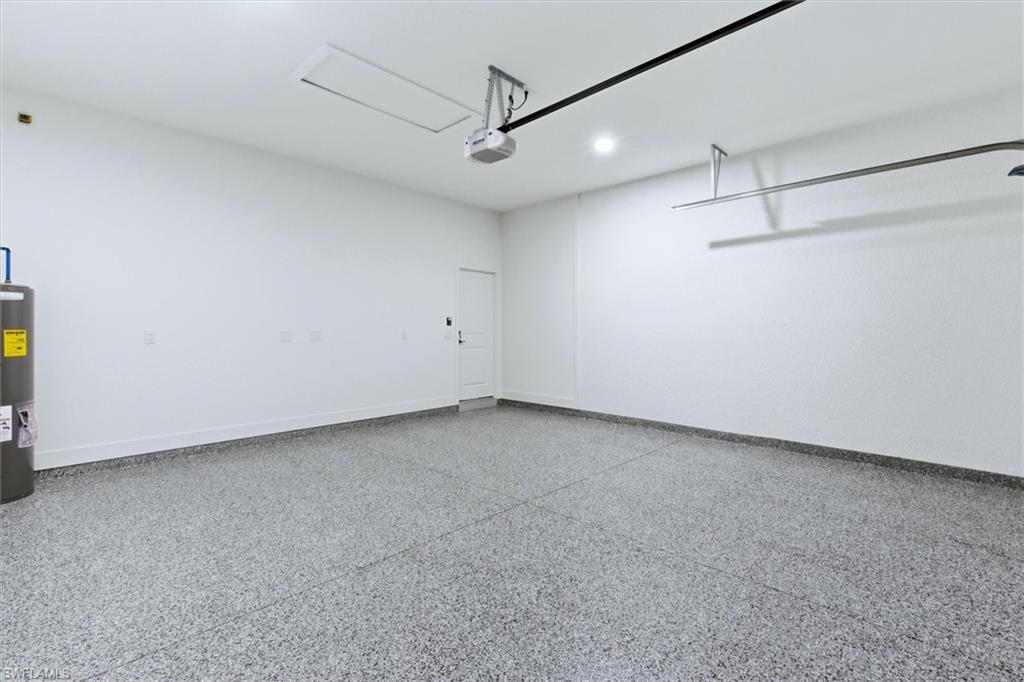 Garage featuring water heater and recessed lighting