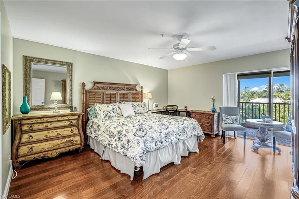 Master Bedroom with dark wood-style flooring, access to outside, and a ceiling fan