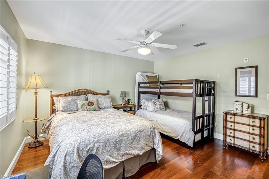 Guest Bedroom featuring dark wood-style flooring and ceiling fan