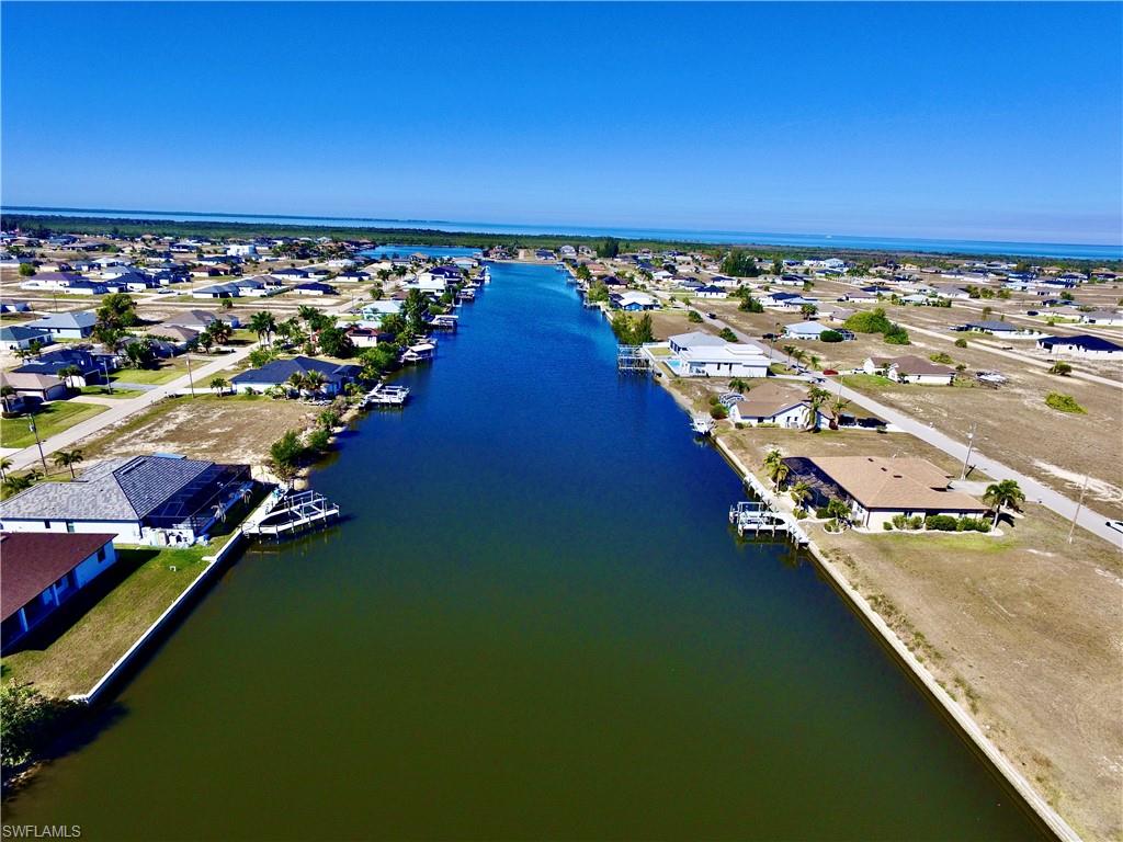 Aerial view of property's location with nearby suburban area and a nearby body of water