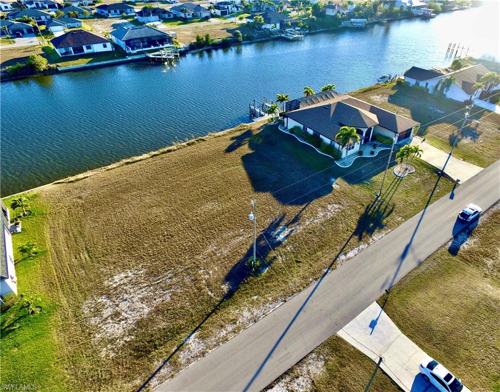 Aerial perspective of suburban area with a nearby body of water
