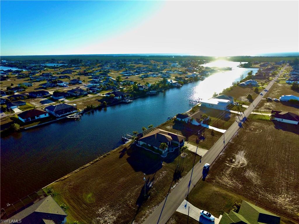 Aerial perspective of suburban area with a nearby body of water
