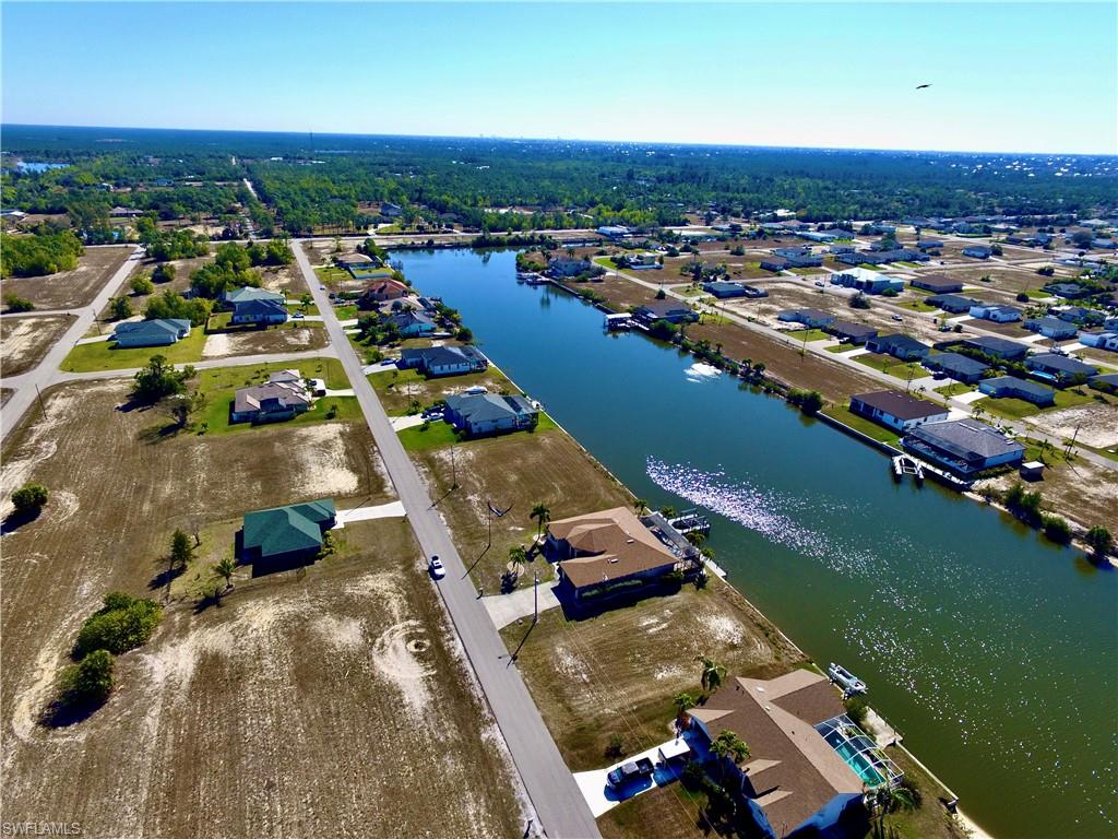 Aerial view of property's location featuring nearby suburban area and a large body of water