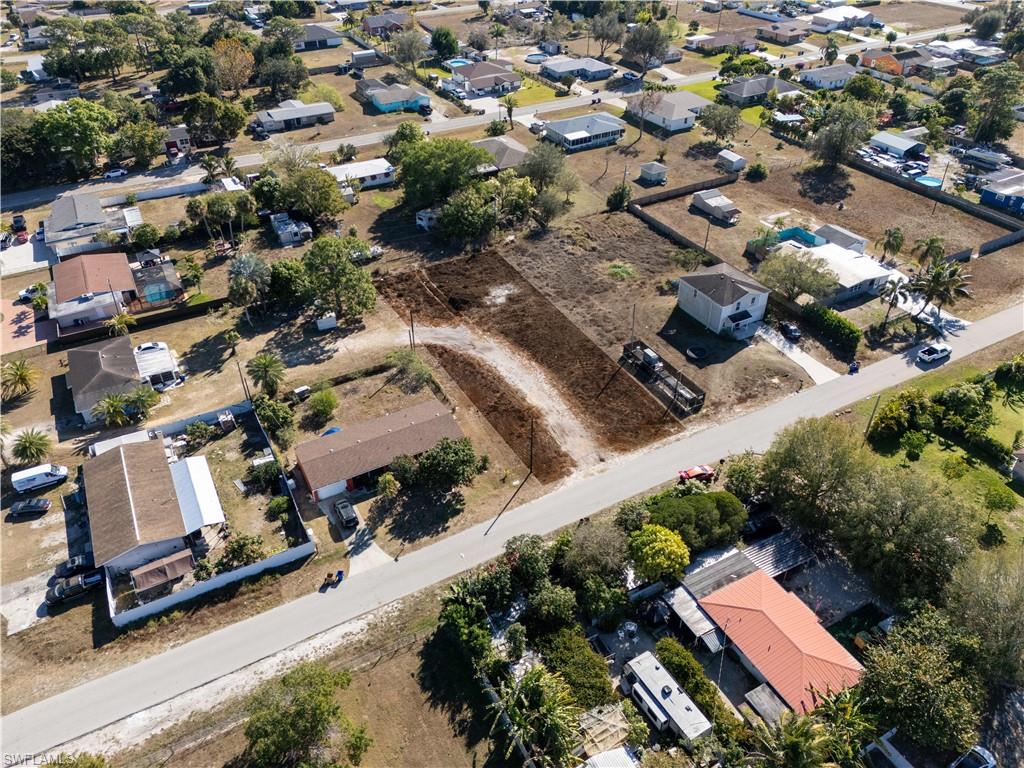 Aerial view of property and surrounding area with nearby suburban area