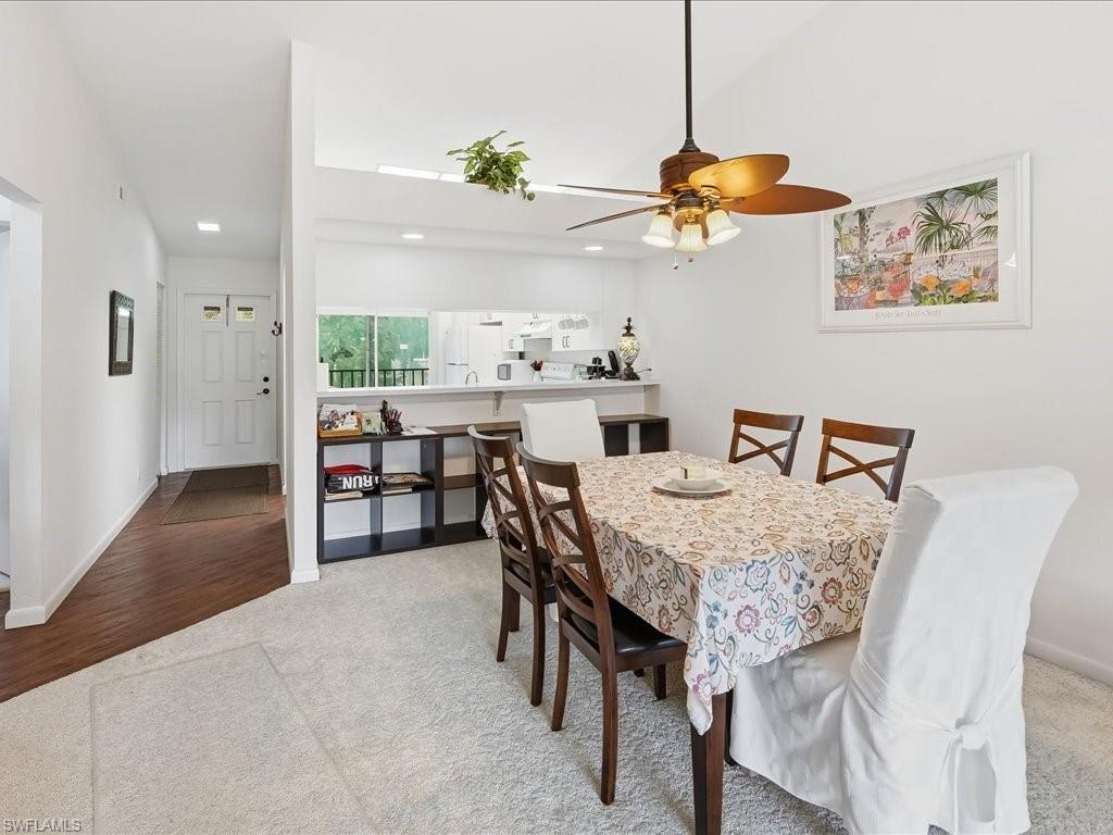 Dining room with light colored carpet, a ceiling fan, and recessed lighting