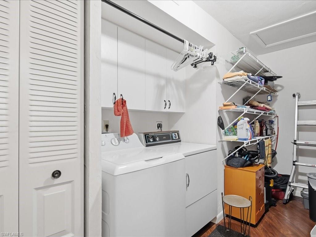 Washroom featuring washer and clothes dryer, dark wood finished floors, and attic access
