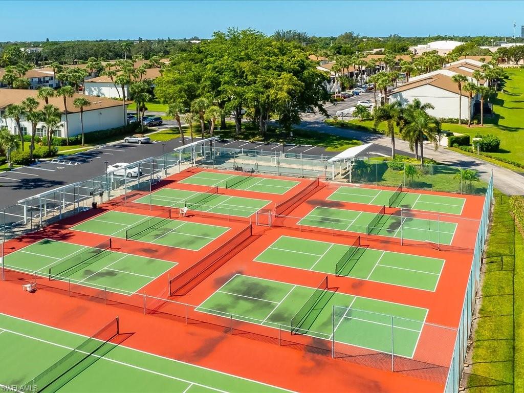 View of tennis court featuring a residential view