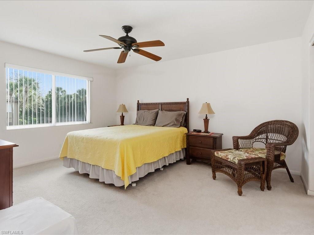 Bedroom featuring light colored carpet and ceiling fan