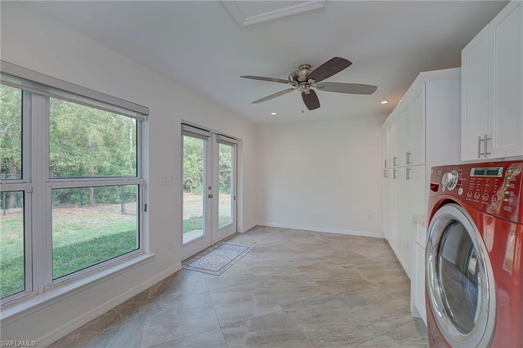 Laundry room with washer / dryer, ceiling fan, cabinet space, recessed lighting, and french doors