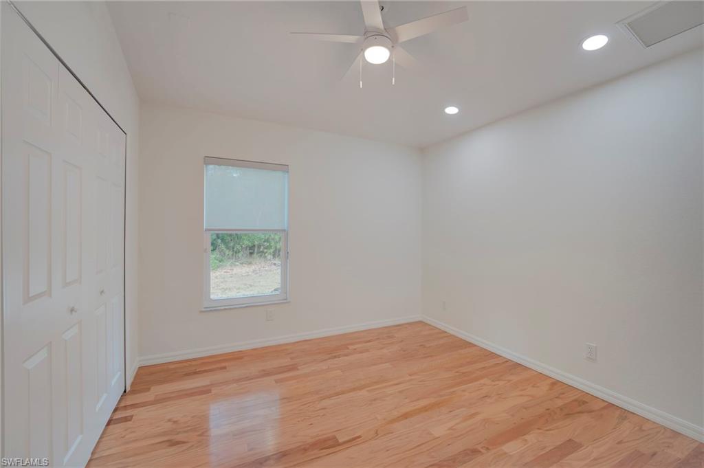 Unfurnished bedroom with light wood-type flooring, recessed lighting, a closet, and a ceiling fan