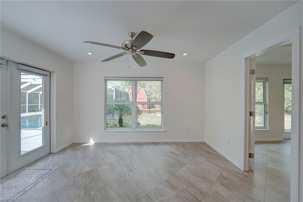 Spare room with a ceiling fan, recessed lighting, and french doors