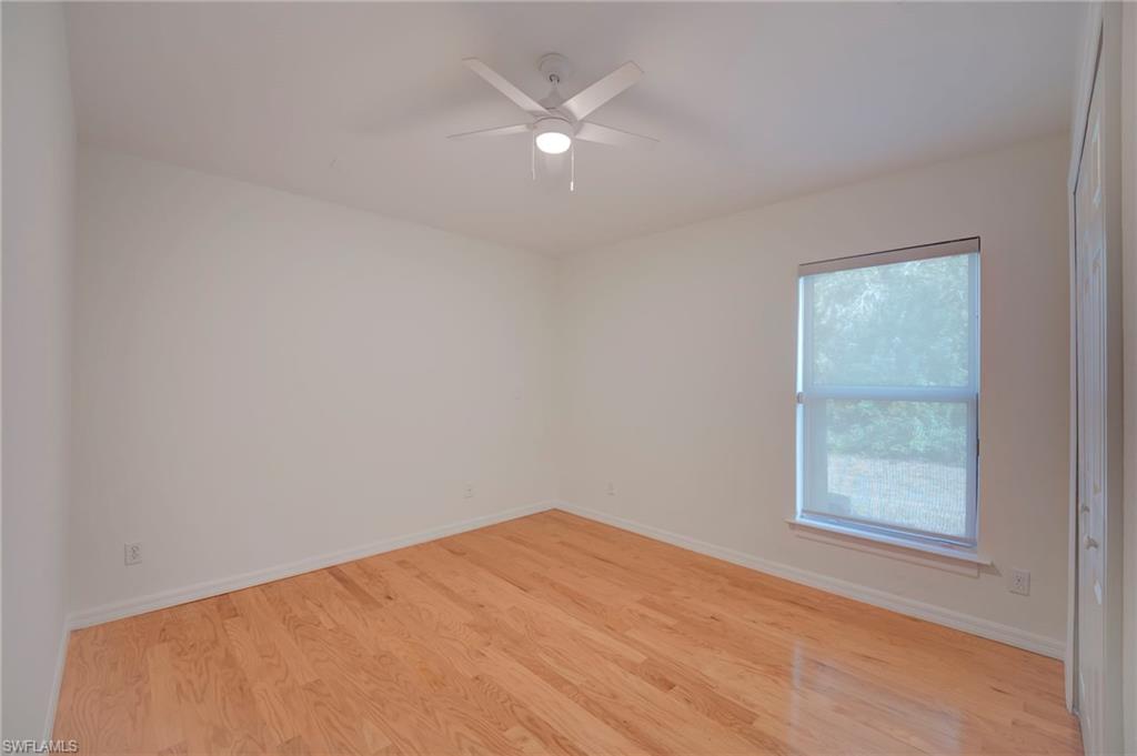Unfurnished room featuring light wood finished floors and a ceiling fan