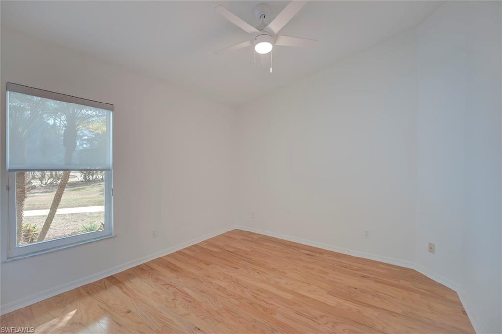 Empty room featuring light wood finished floors and ceiling fan