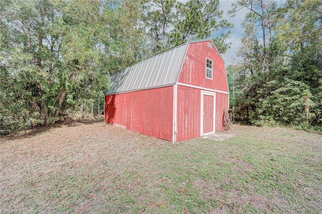 View of barn with a yard