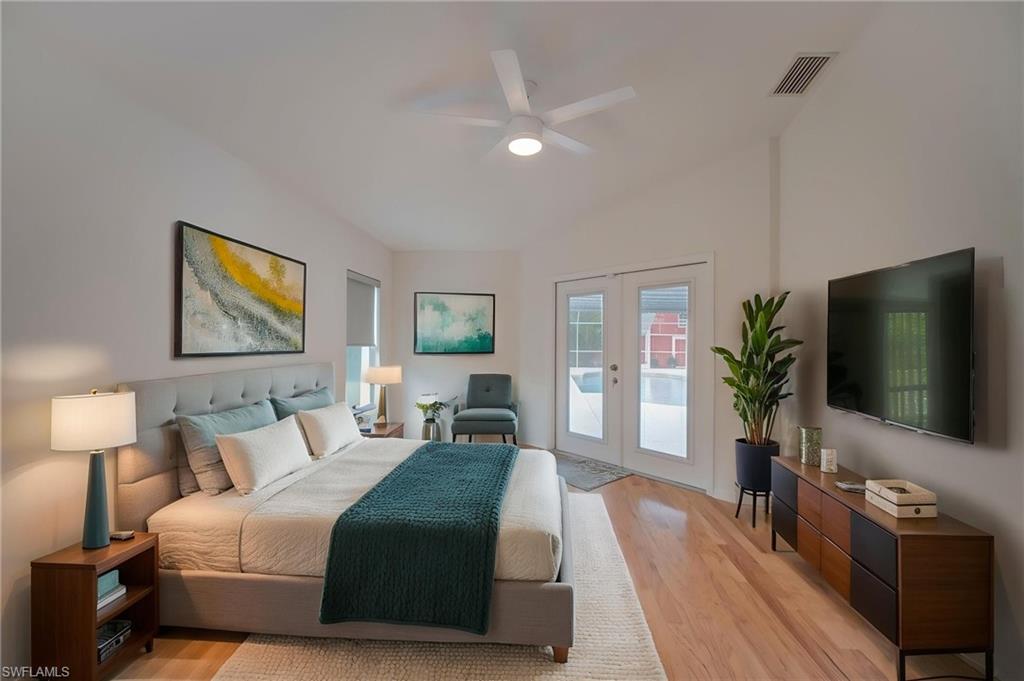 Bedroom featuring french doors, light wood-style floors, access to outside, and ceiling fan