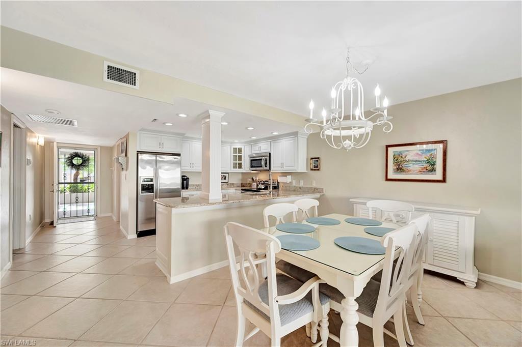Dining area/kitchen with view toward screened front door offering great cross - breezes!