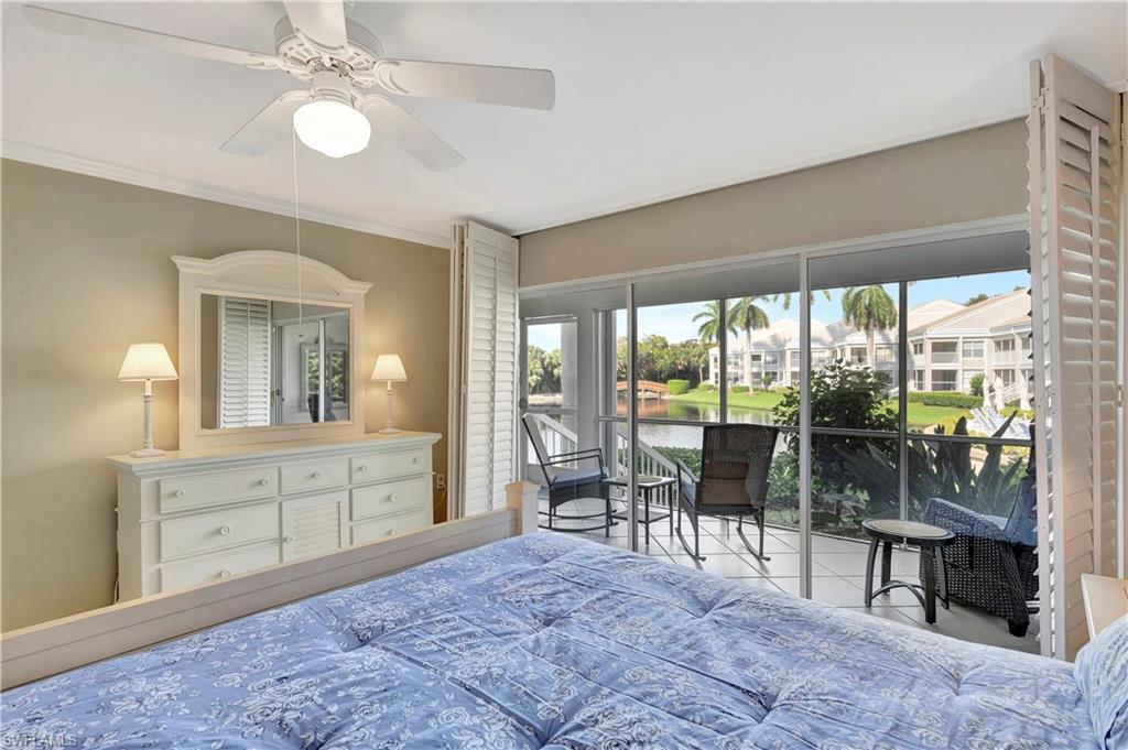 Primary Bedroom sliders open to the screened lanai and close with plantation shutters for privacy.