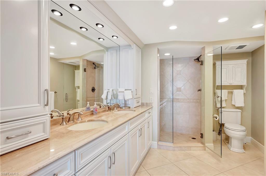 Primary bathroom with dual sinks and a walk in shower.