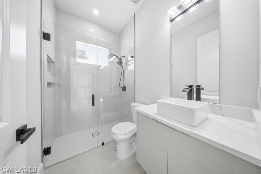 Bathroom with a stall shower and vanity