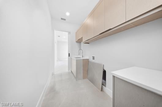 Laundry room with hookup for a washing machine, cabinet space, recessed lighting, and concrete flooring