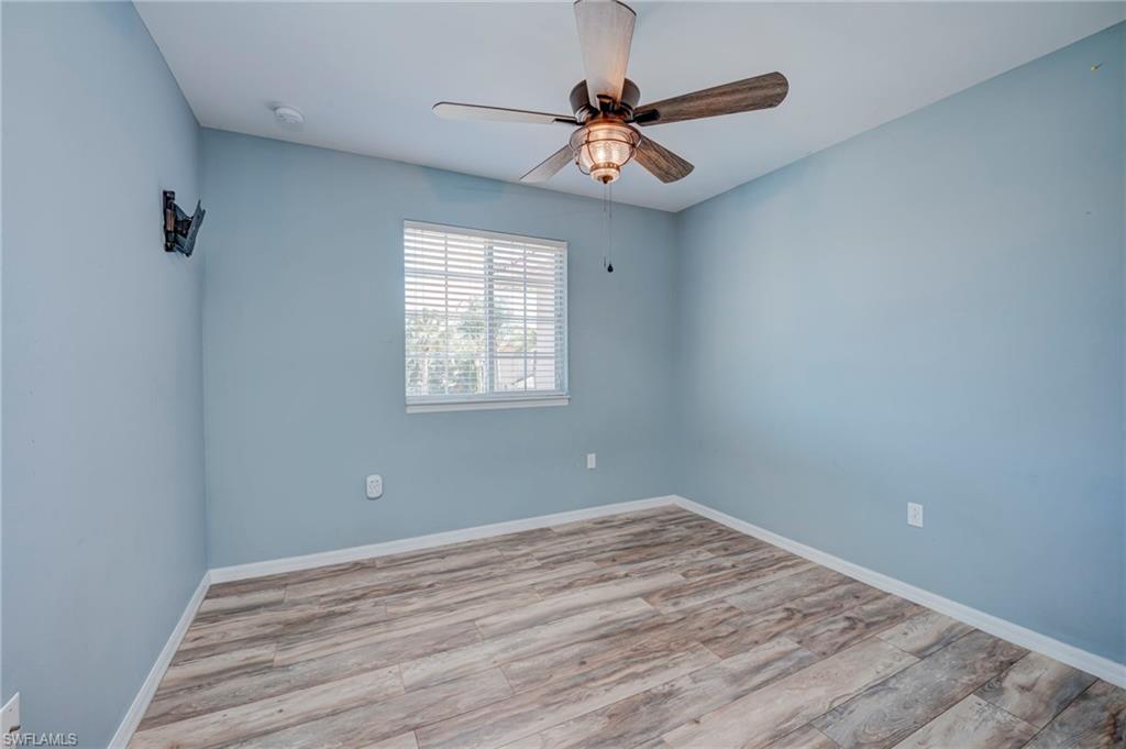 Empty room with light wood-type flooring and ceiling fan