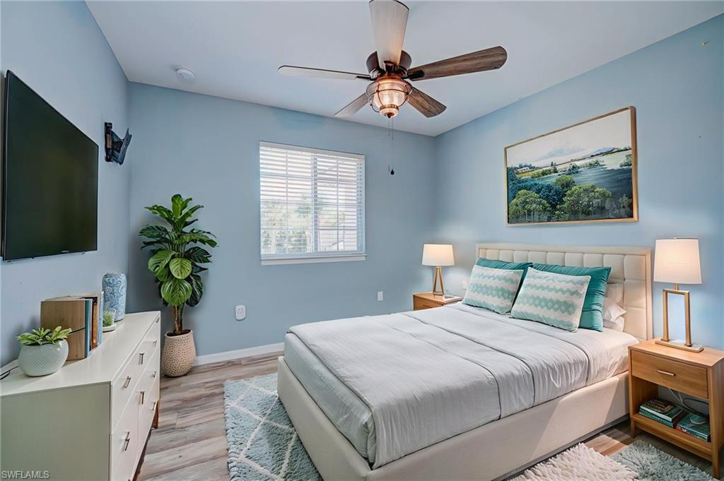 Bedroom with light wood finished floors and ceiling fan