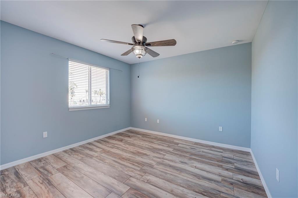 Unfurnished room featuring light wood-style floors and ceiling fan