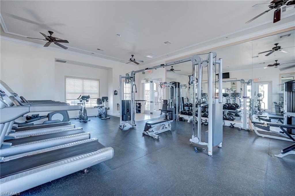 Exercise room featuring a ceiling fan and crown molding