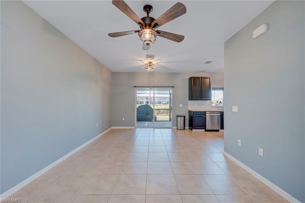 Unfurnished living room with a ceiling fan and light tile patterned floors