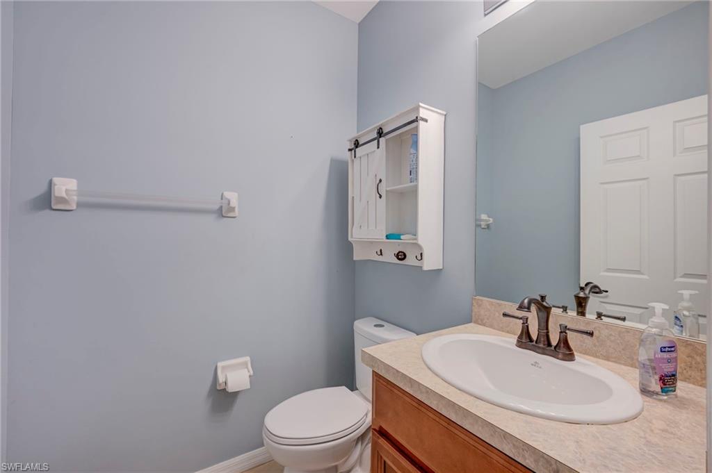 Half bath featuring vanity and toilet