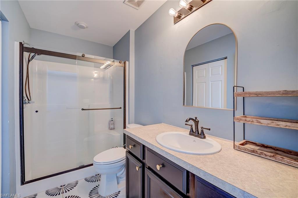 Full bath with vanity and a stall shower
